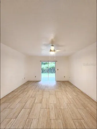 a view of a room with wooden floor staircase and a kitchen space