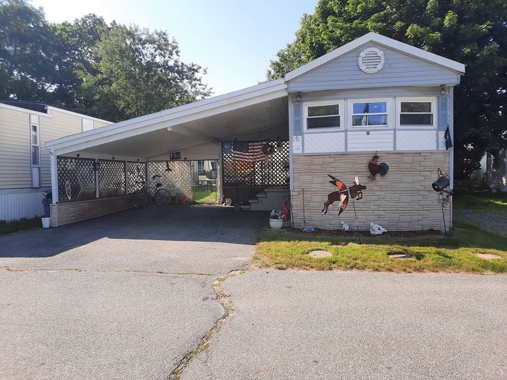270 Littleton Road, Unit 182 Chelmsford, MA 01824 - Photo 2 of 22 a front view of a house with a yard and garage