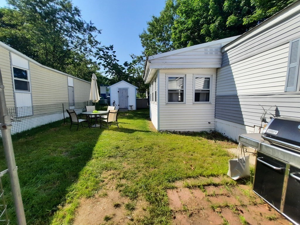 270 Littleton Road, Unit 182 Chelmsford, MA 01824 - Photo 6 of 22 a view of a backyard with sitting area