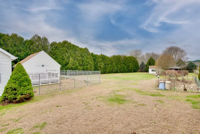 a view of a swimming pool and trees in the background