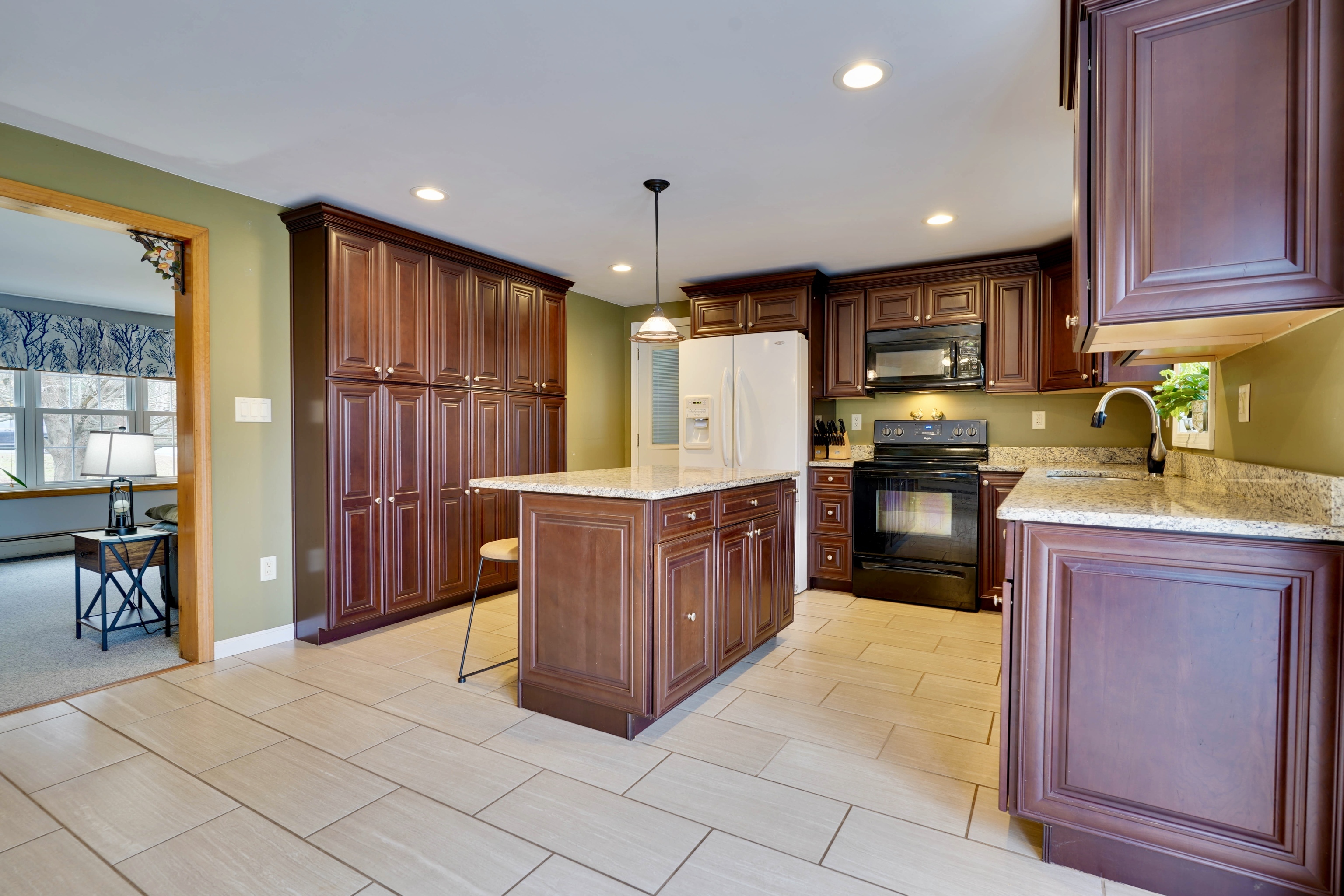 85 Bailey Woods Road Brooklyn, CT 06234 - Photo 4 of 35 a kitchen with stainless steel appliances a stove sink and cabinets