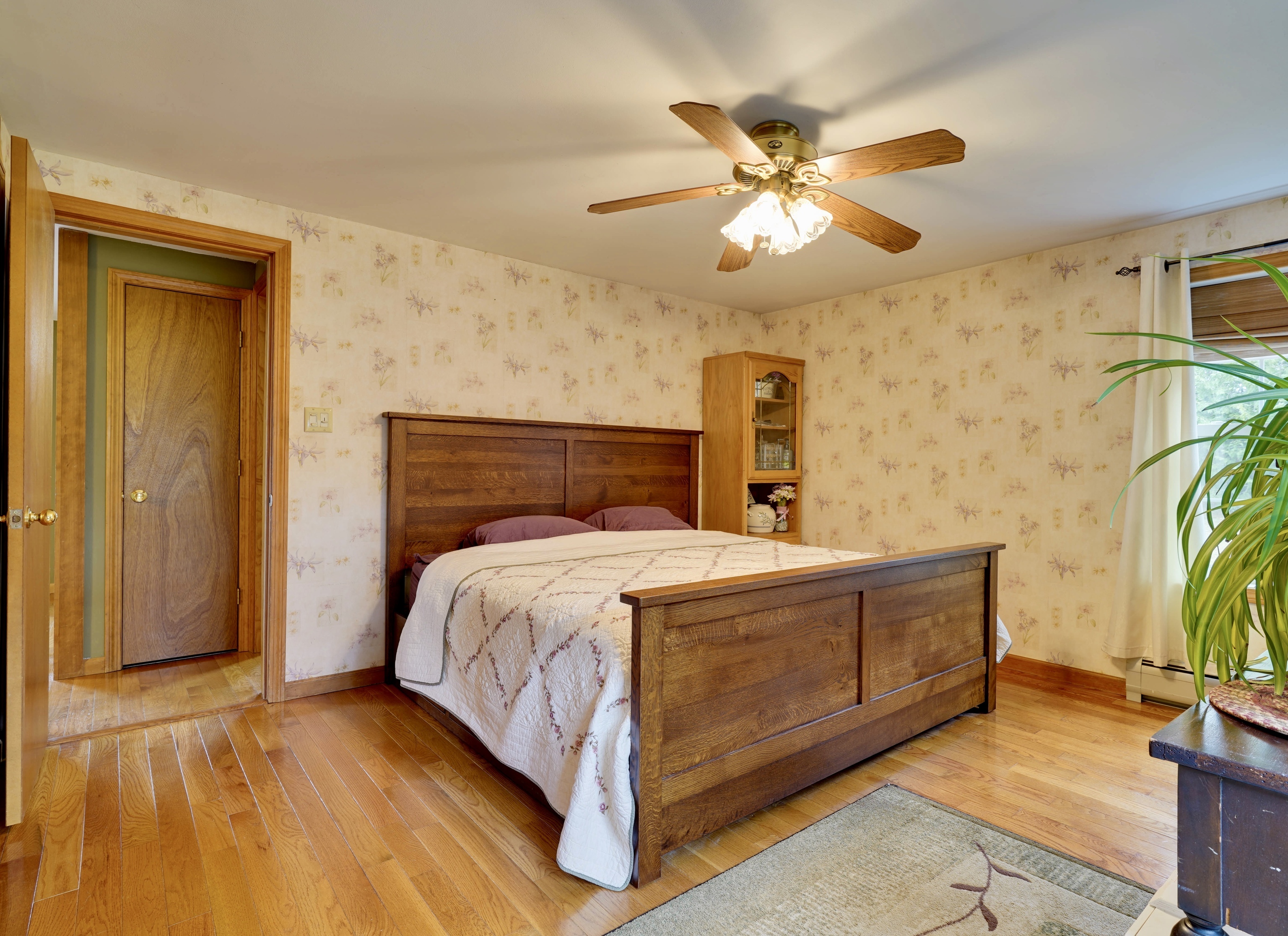 85 Bailey Woods Road Brooklyn, CT 06234 - Photo 9 of 35 a bedroom with a bed and a chandelier