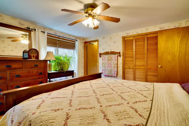 a bedroom with a large bed and a large window