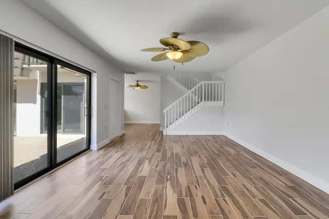 a view of an empty room with wooden floor