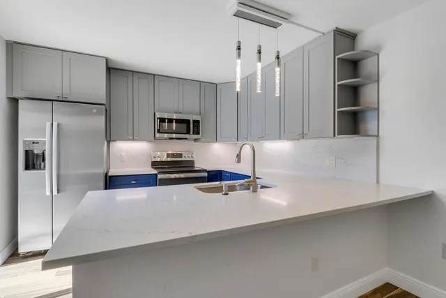 a kitchen with a refrigerator and microwave