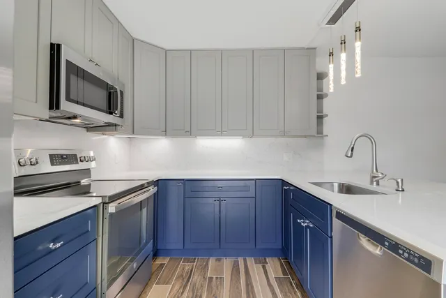 a view of a patio with table and chairs potted plants and a large tree