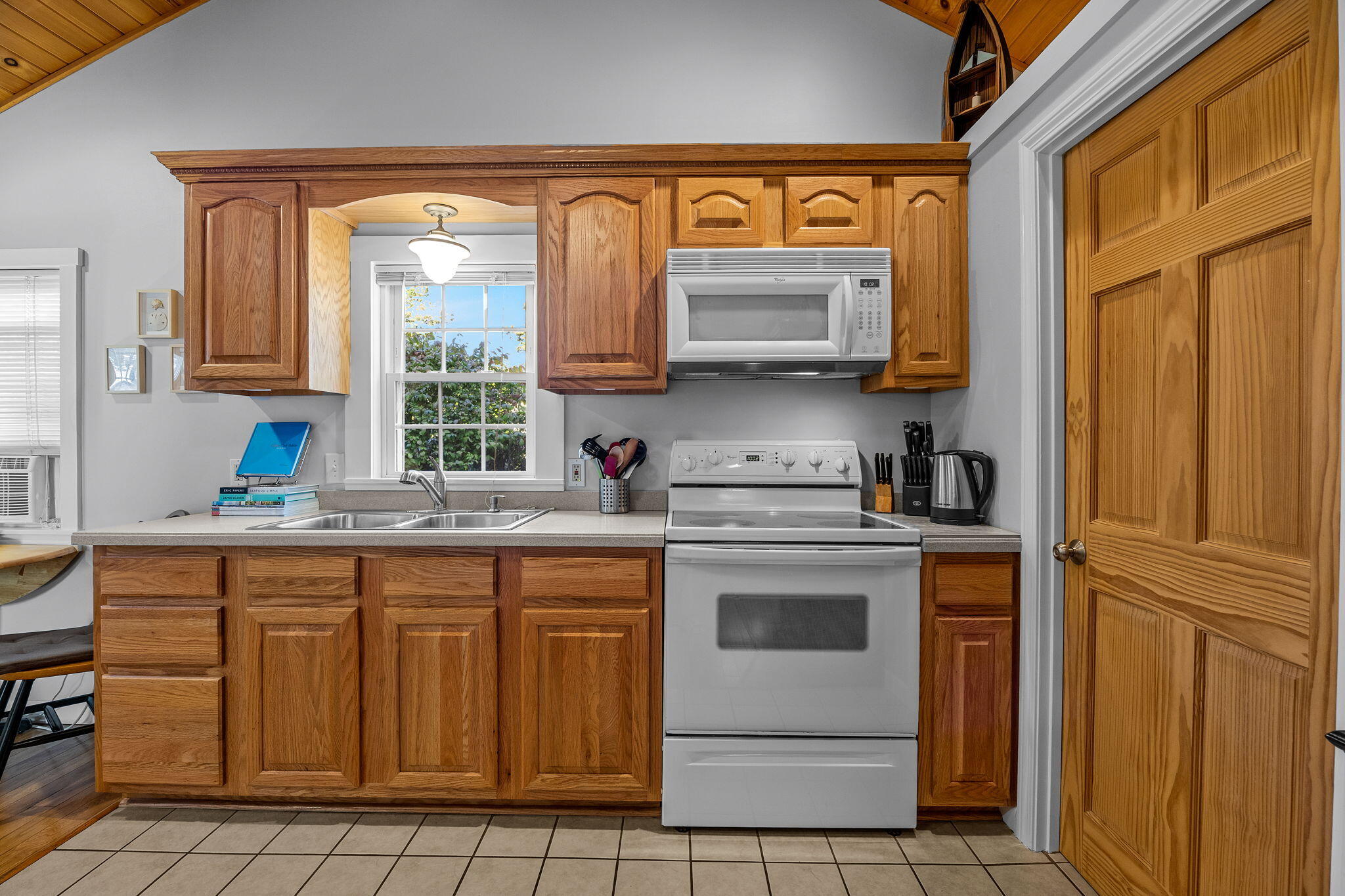 2032 State Hwy Route, Unit F/ (6) Wellfleet, MA 02667 - Photo 7 of 37 a kitchen with a stove a sink and a microwave