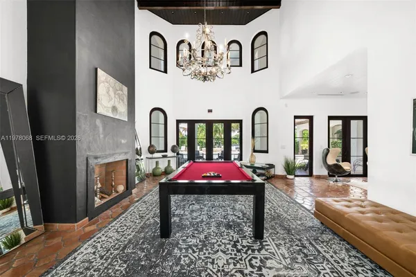a living room with furniture large window and flat screen tv