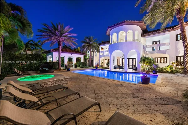 a dining room with furniture a kitchen and a chandelier