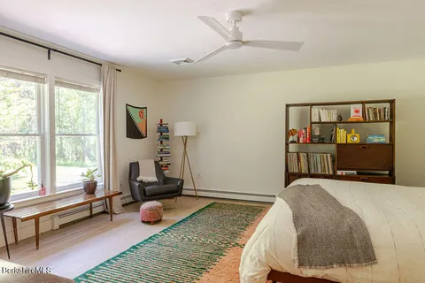 a bedroom with a bed a couch and a window