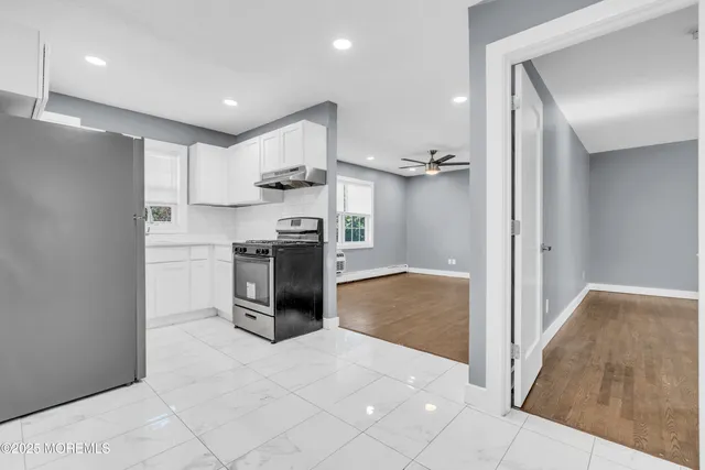 a kitchen with stainless steel appliances granite countertop a refrigerator and a sink