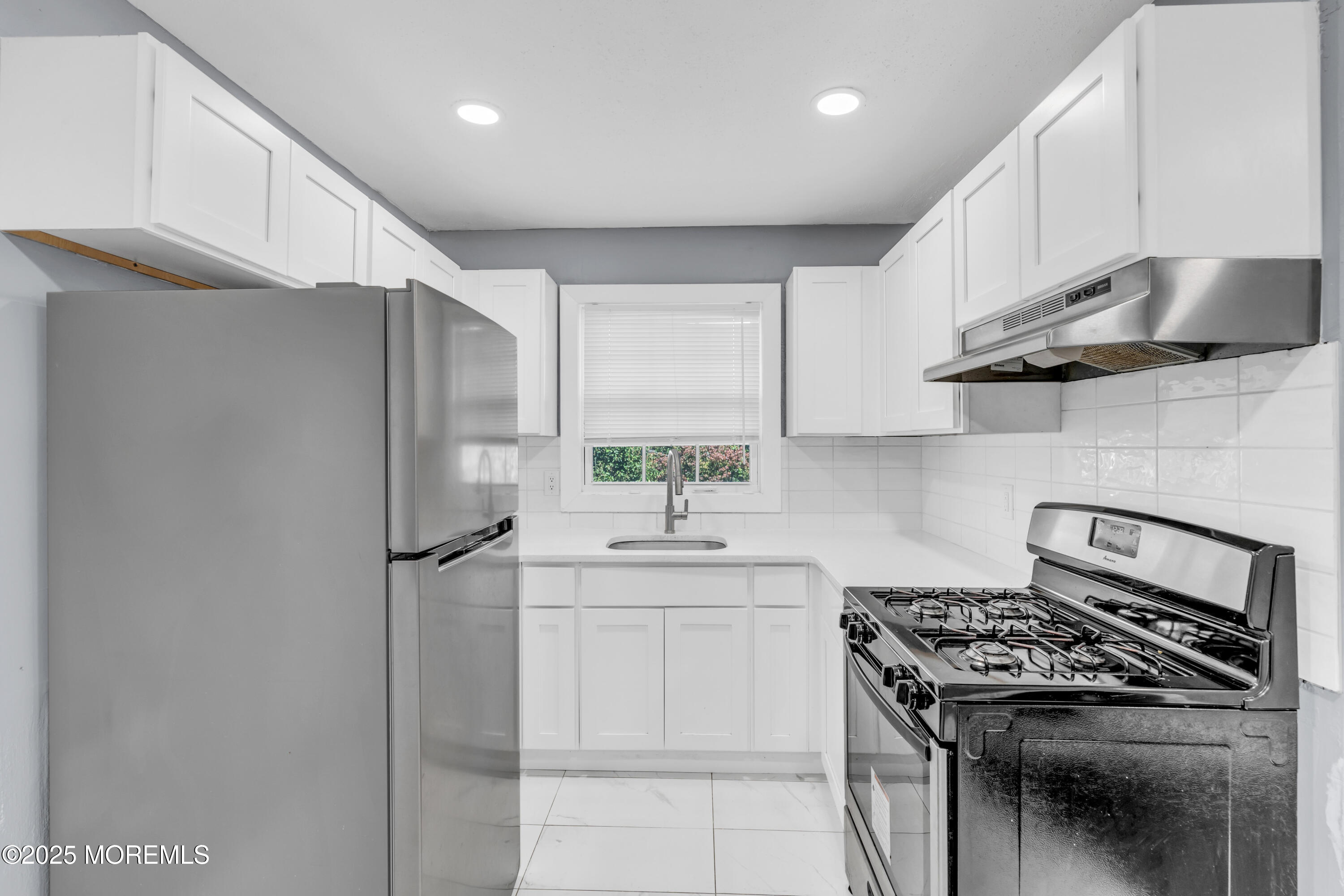 364 Westwood Avenue, Unit 83 Long Branch, NJ 07740 - Photo 13 of 17 a kitchen with stainless steel appliances a sink stove and refrigerator