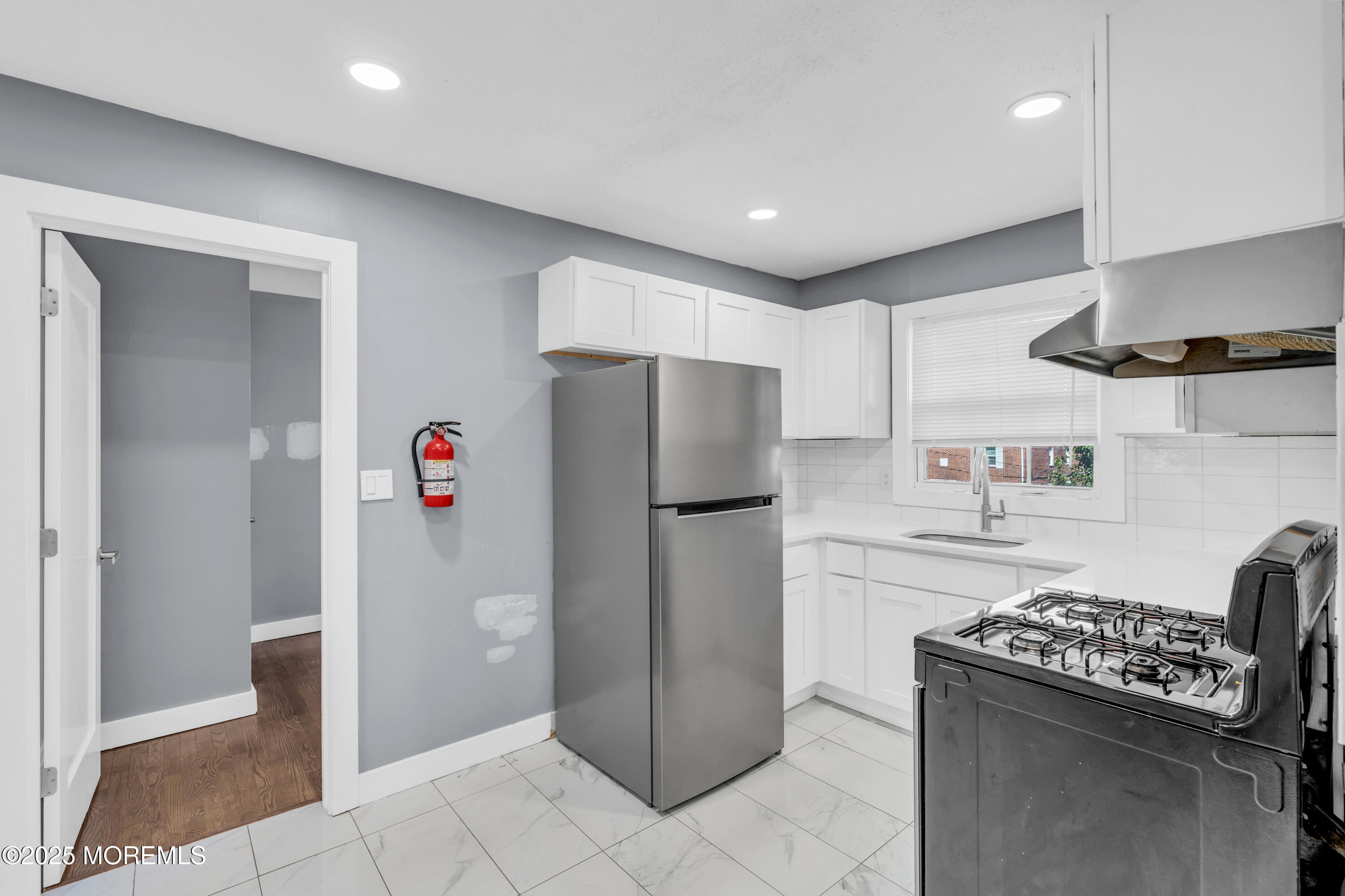 364 Westwood Avenue, Unit 83 Long Branch, NJ 07740 - Photo 14 of 17 a kitchen with a refrigerator and a stove top oven