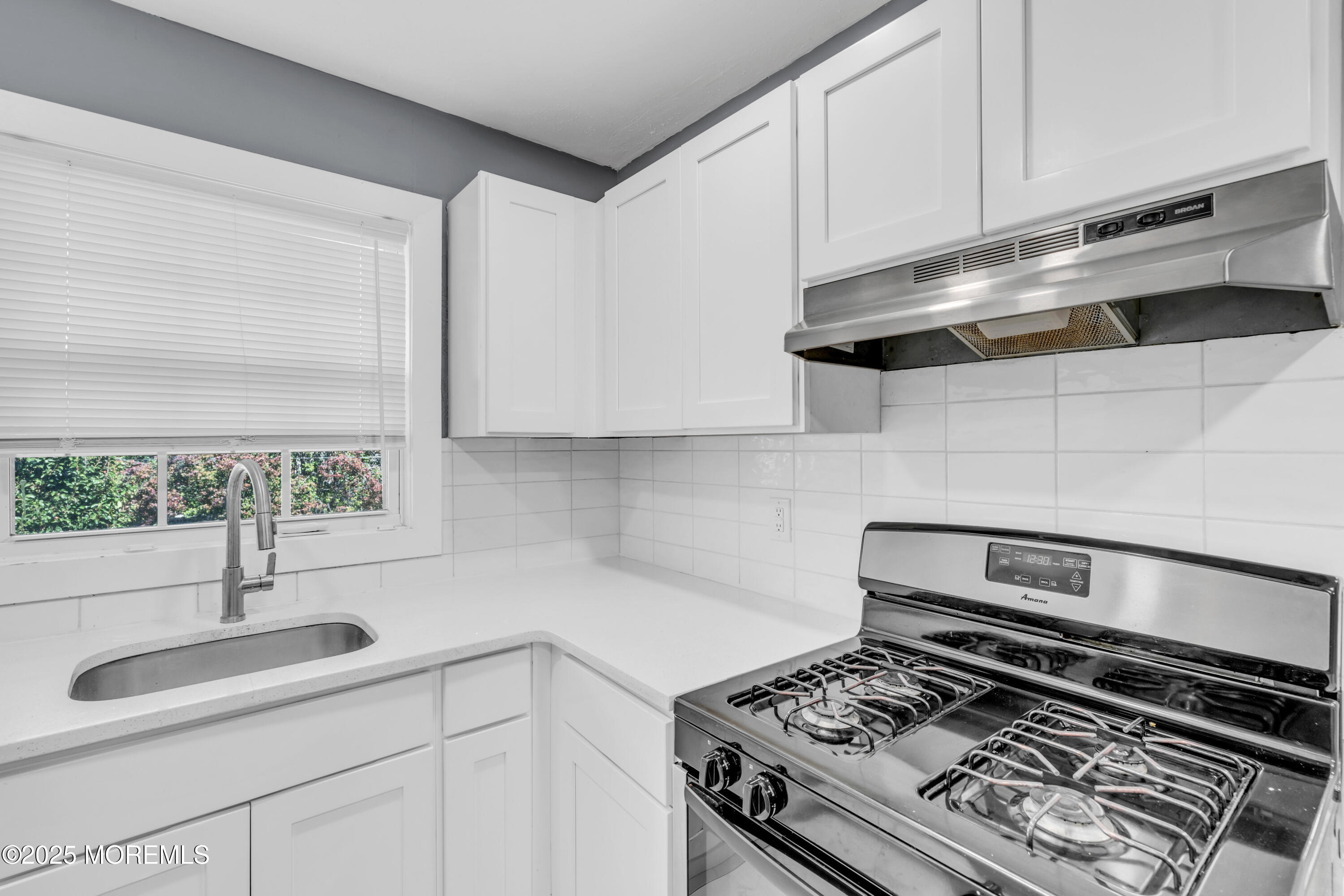 364 Westwood Avenue, Unit 83 Long Branch, NJ 07740 - Photo 15 of 17 a kitchen with a stove and a sink