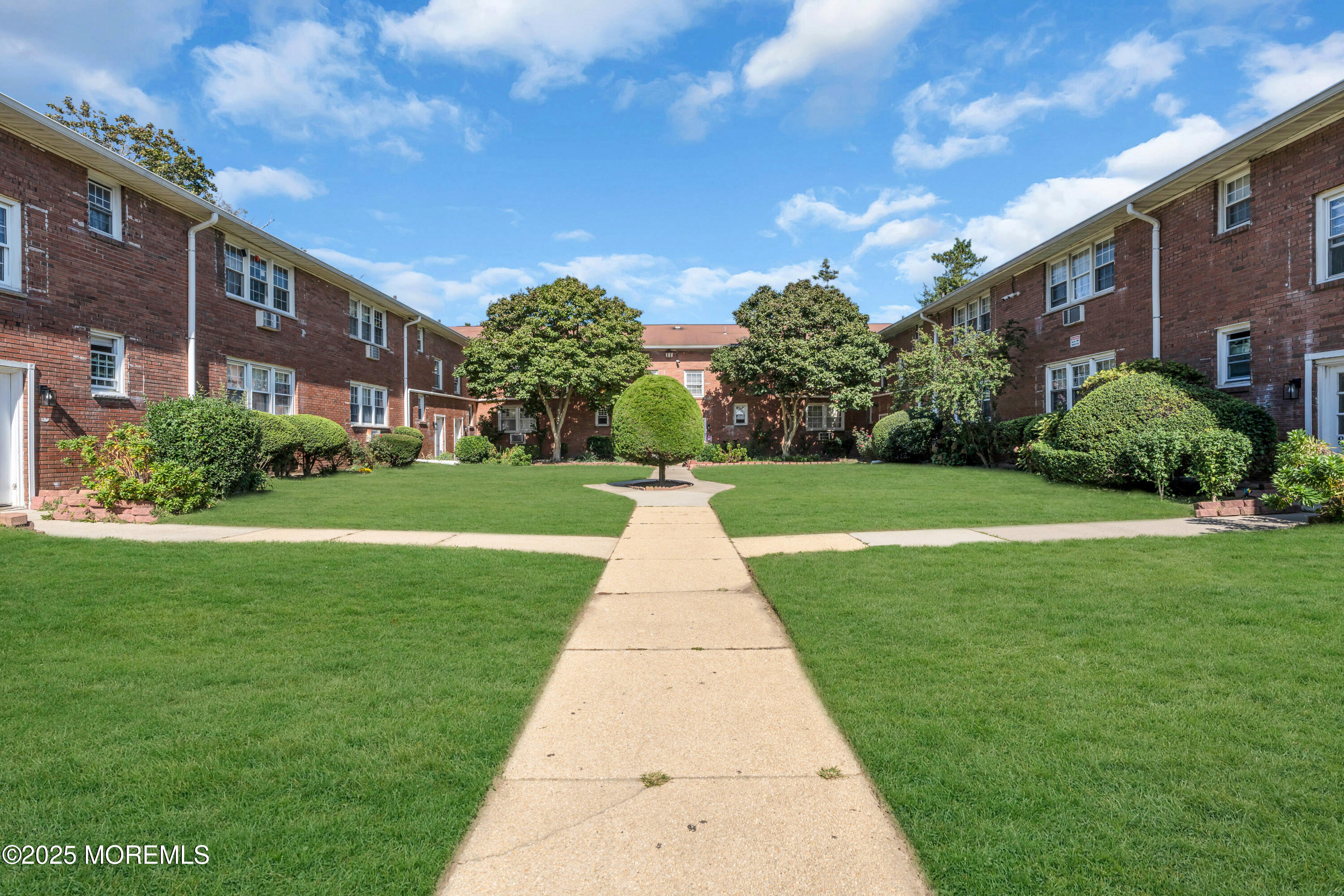 364 Westwood Avenue, Unit 83 Long Branch, NJ 07740 - Photo 2 of 17 a view of a building with a yard