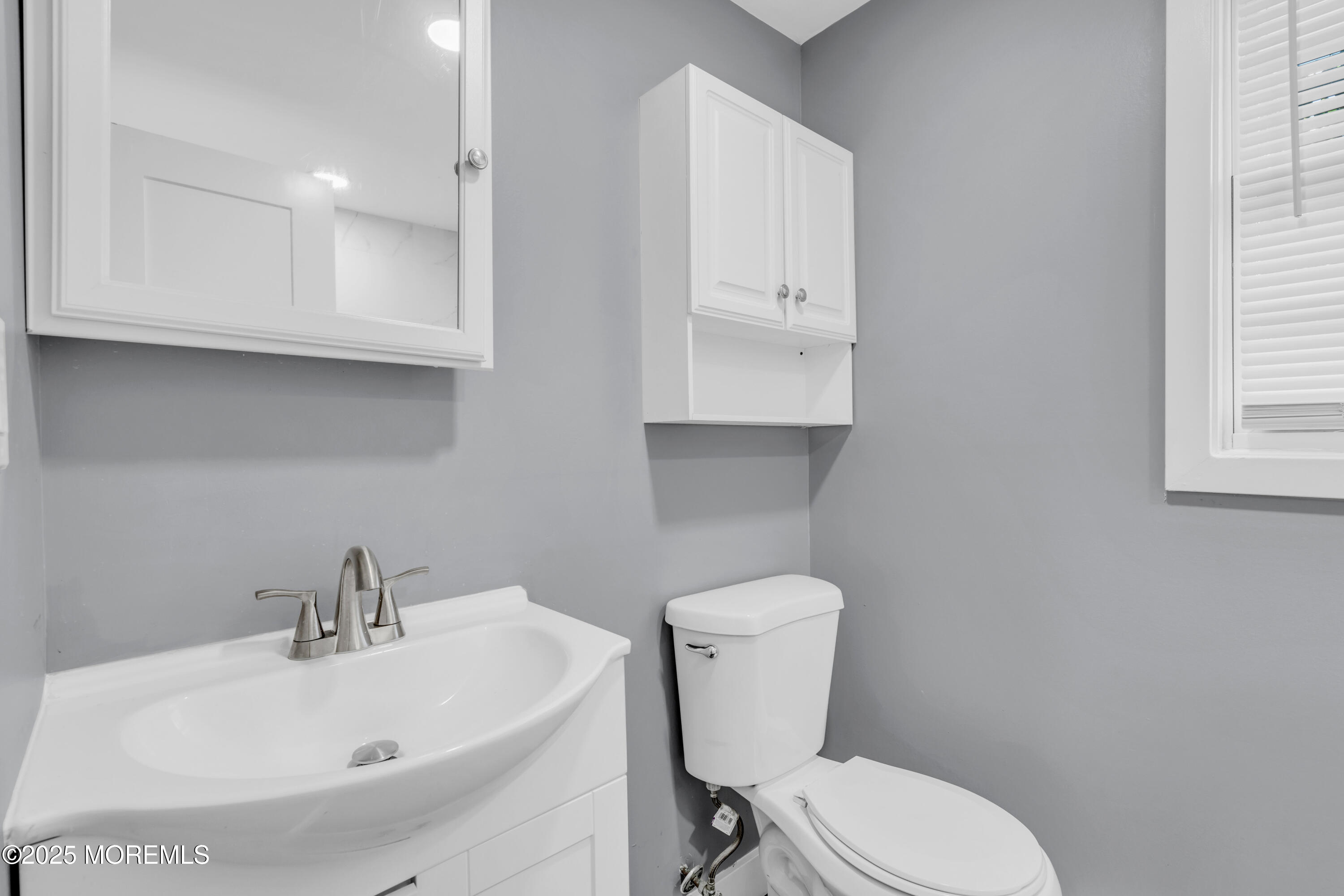 364 Westwood Avenue, Unit 83 Long Branch, NJ 07740 - Photo 5 of 17 a white toilet sitting next to a bathroom sink