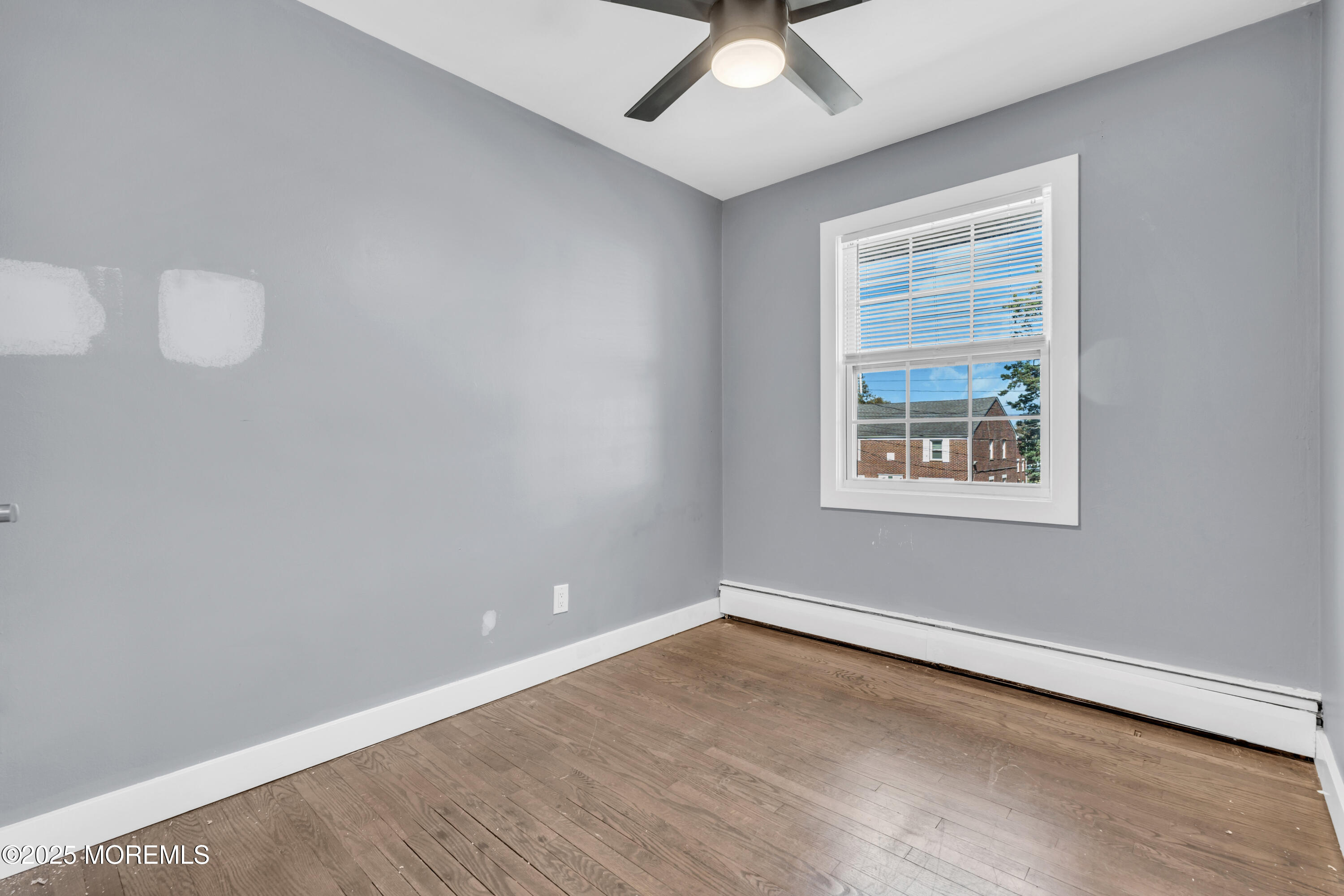 364 Westwood Avenue, Unit 83 Long Branch, NJ 07740 - Photo 7 of 17 an empty room with a window
