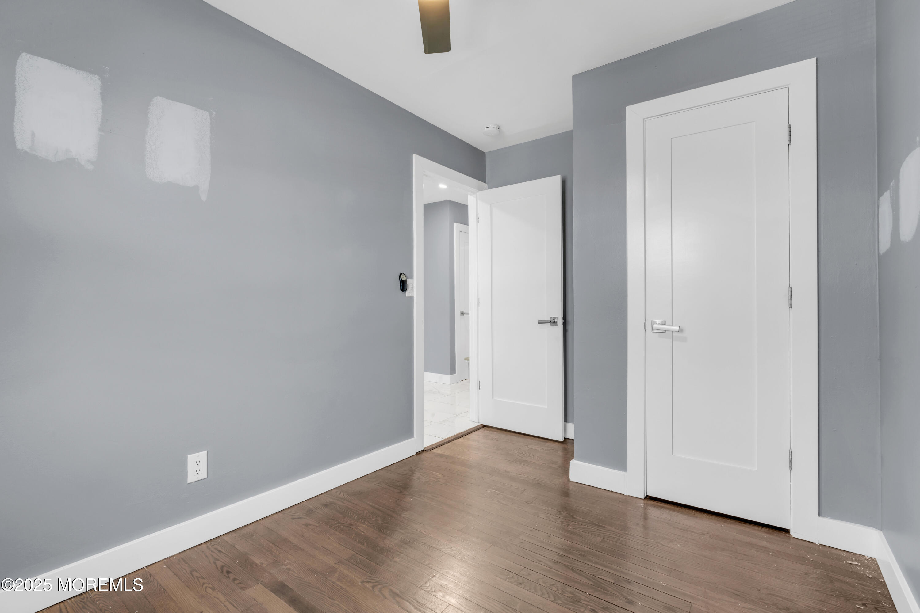 364 Westwood Avenue, Unit 83 Long Branch, NJ 07740 - Photo 8 of 17 a view of an empty room with wooden floor