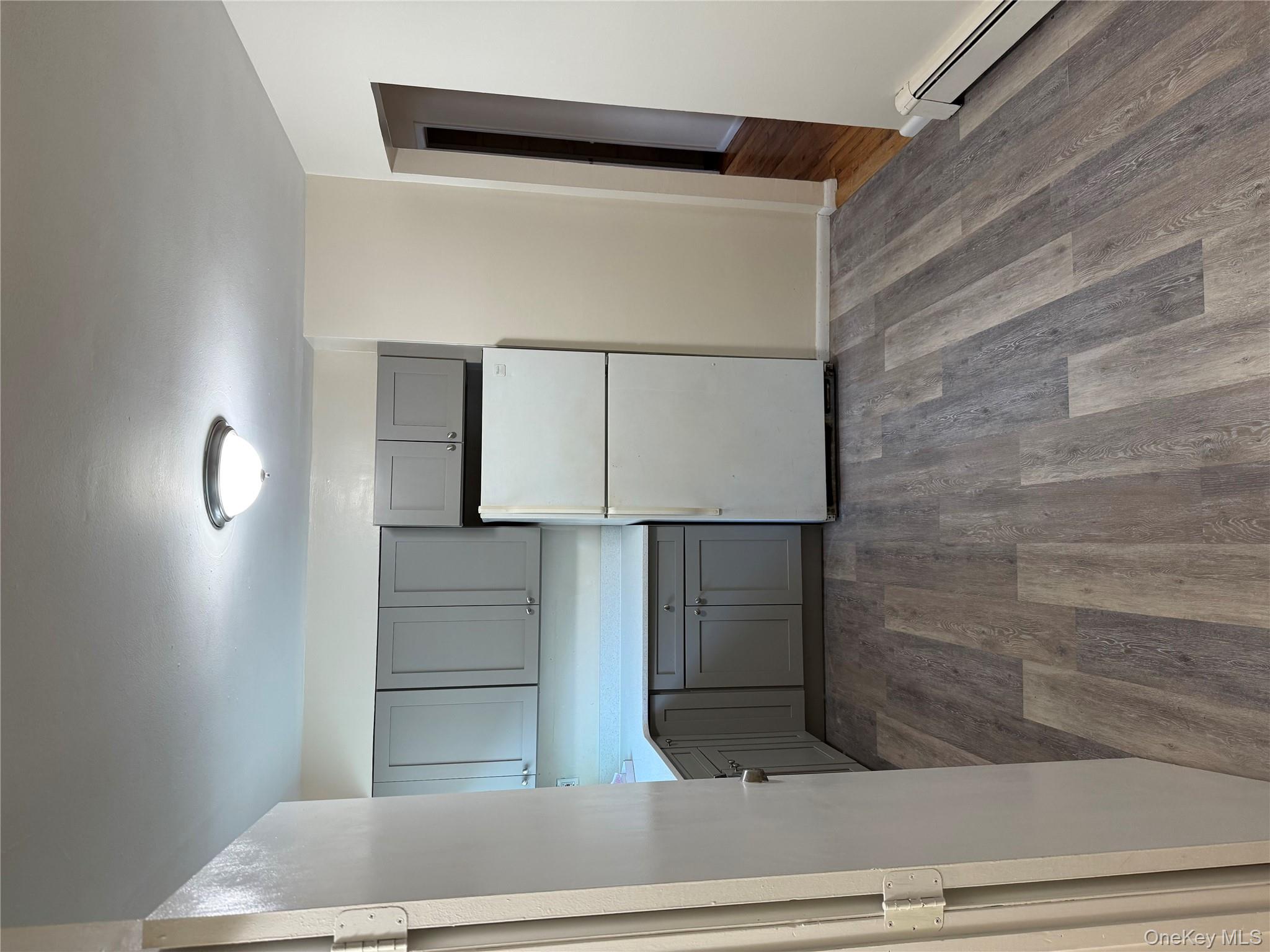 a view of kitchen with a refrigerator cabinets and a ceiling fan