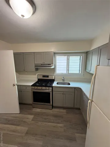 a kitchen with a stove a sink and a refrigerator