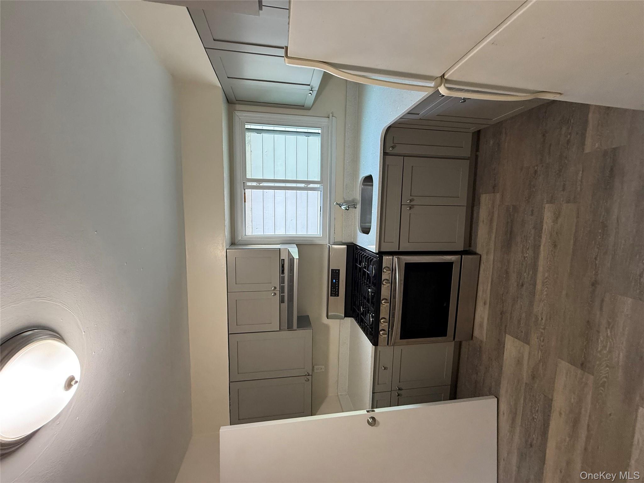 102-12 216th Street Queens, NY 11429 - Photo 4 of 10 a kitchen with a stove a sink and a refrigerator