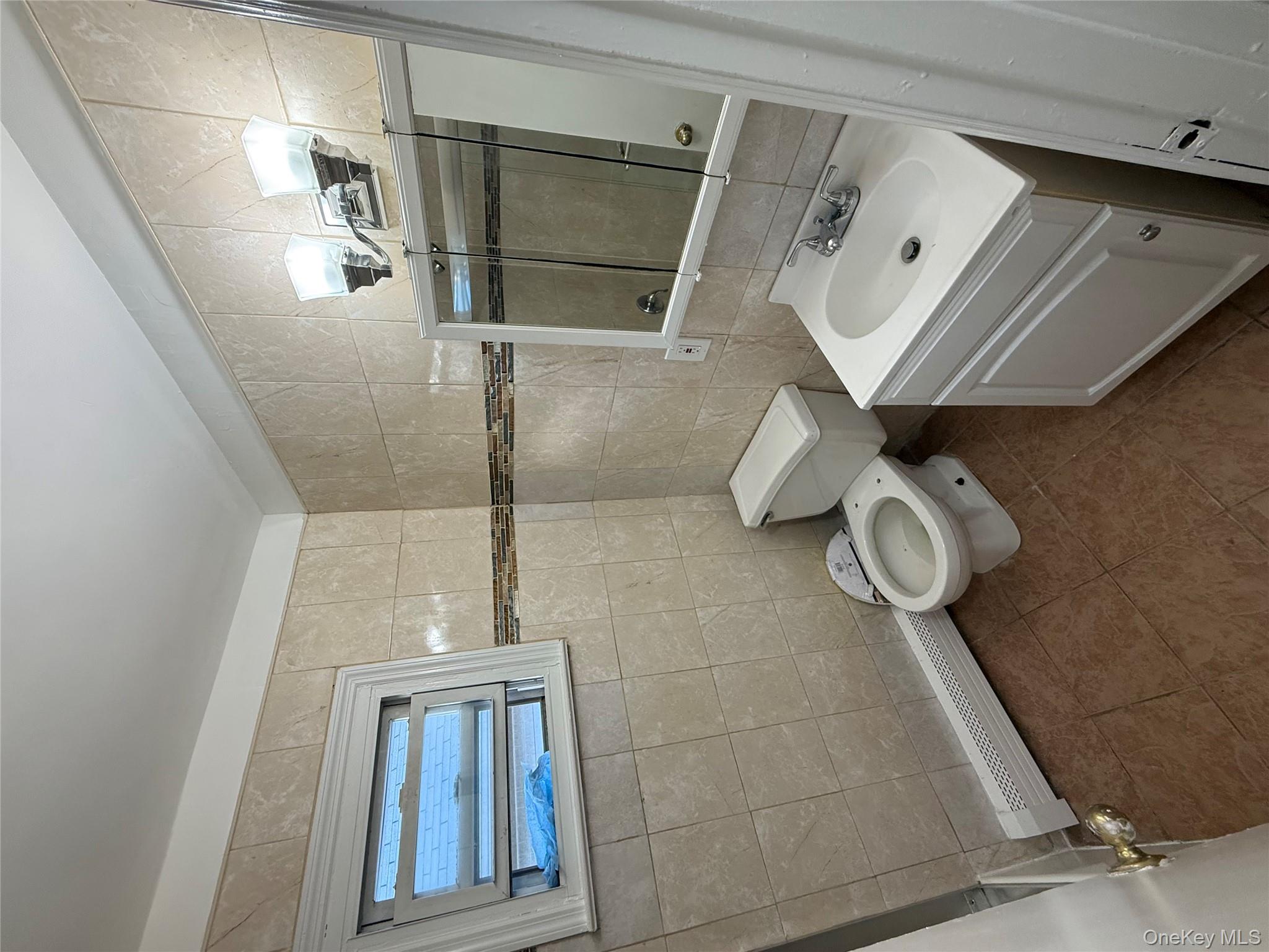102-12 216th Street Queens, NY 11429 - Photo 6 of 10 a bathroom with a sink toilet and shower