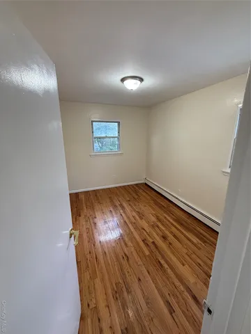 a view of room with wooden floor