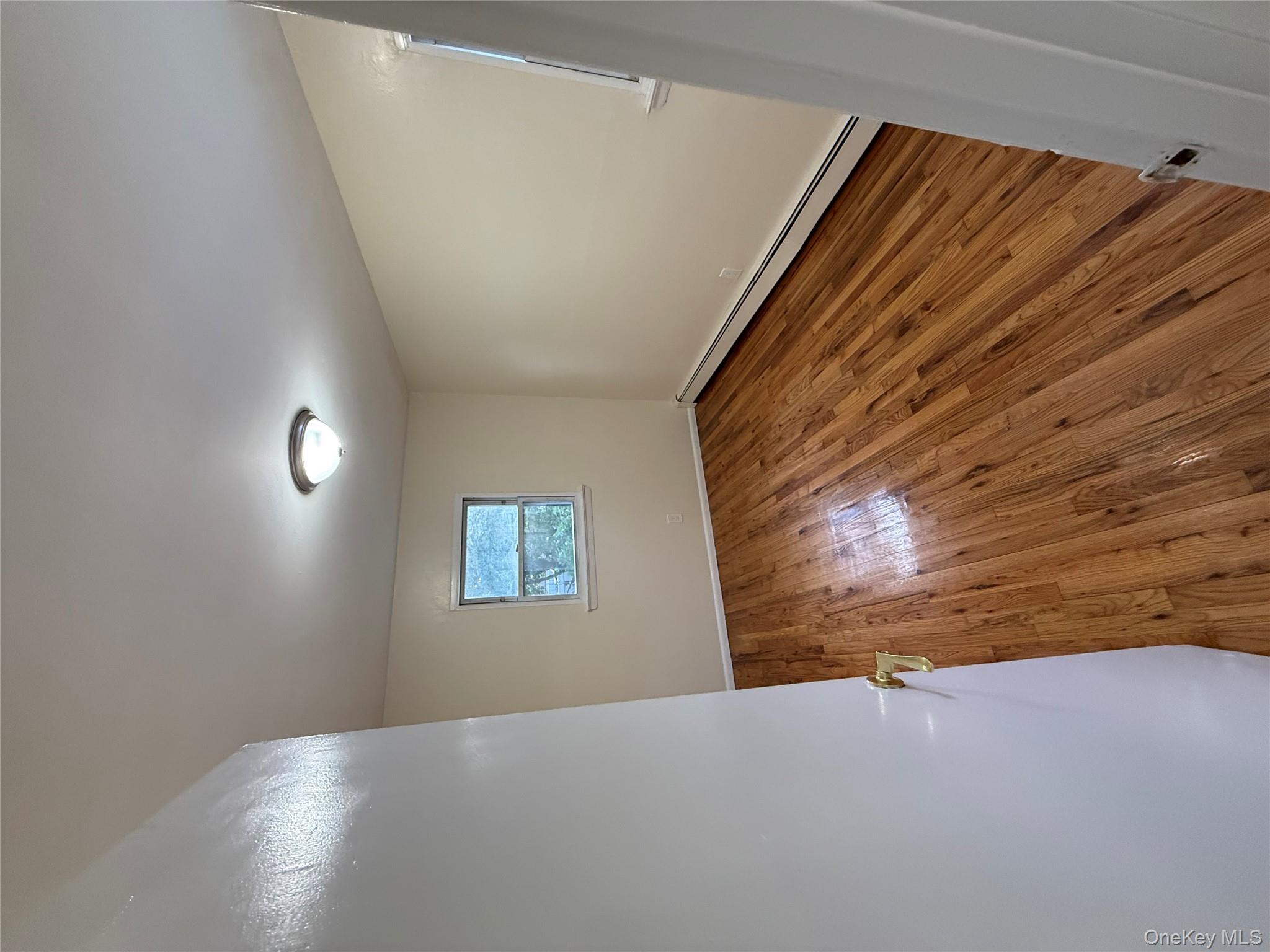 102-12 216th Street Queens, NY 11429 - Photo 8 of 10 a view of room with wooden floor