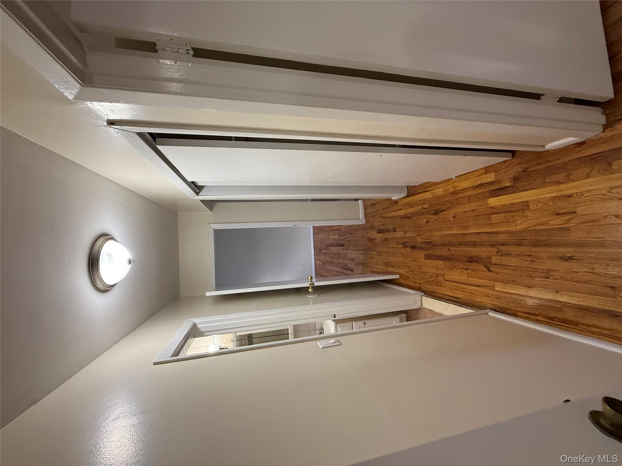 102-12 216th Street Queens, NY 11429 - Photo 9 of 10 a view of a hallway with wooden floor and staircase