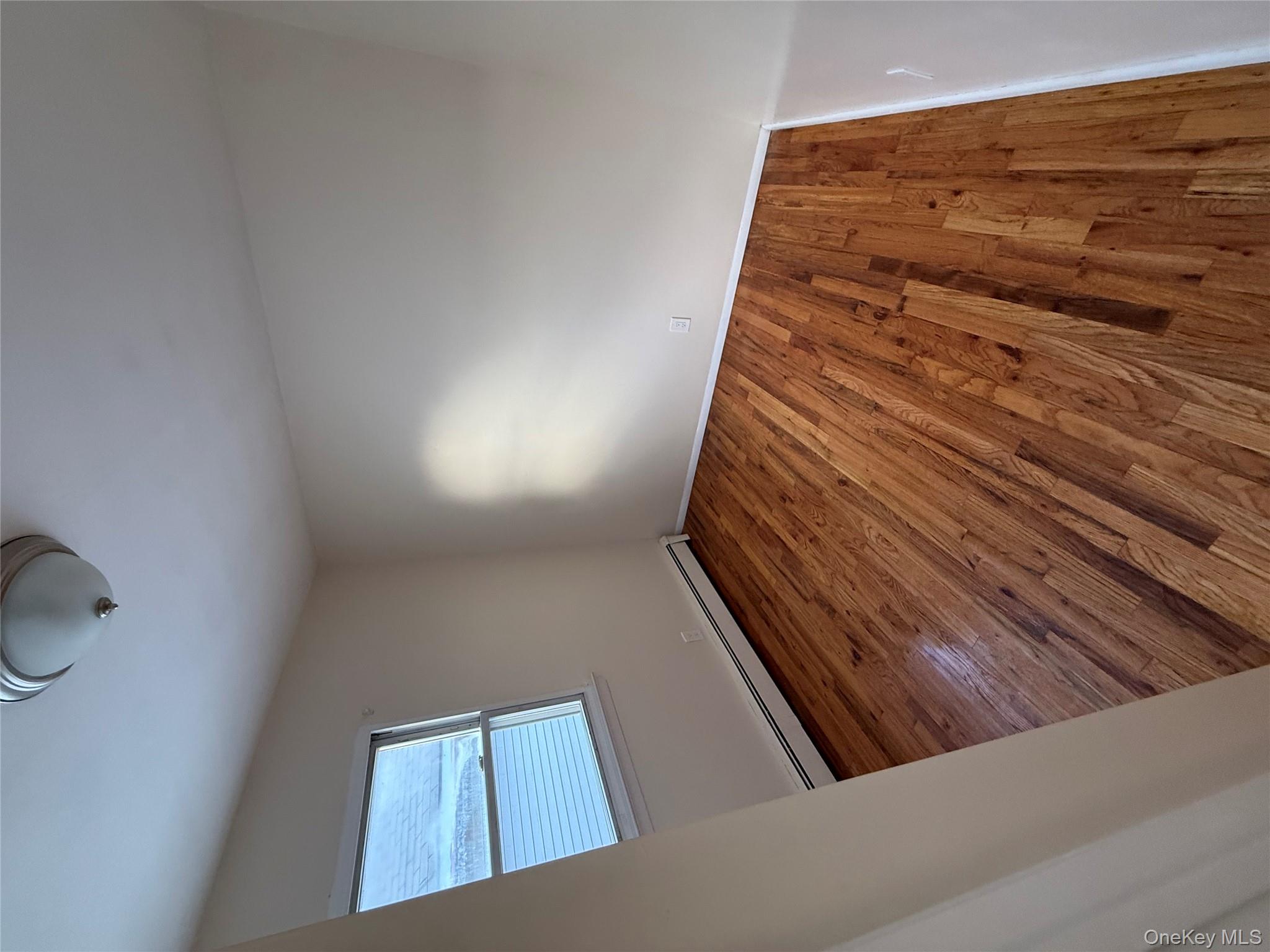 102-12 216th Street Queens, NY 11429 - Photo 10 of 10 a view of wooden floor in a room
