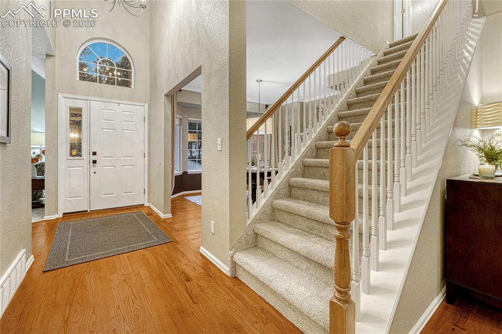 15585 Falcon Ridge Court Colorado Springs, CO 80921 - Photo 2 of 50 a view of an entryway with wooden floor and a livingroom view