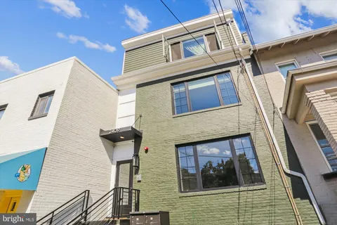 a view of a brick house with large windows