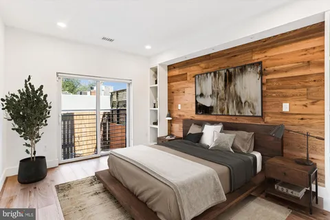 a bedroom with a large bed and a large window