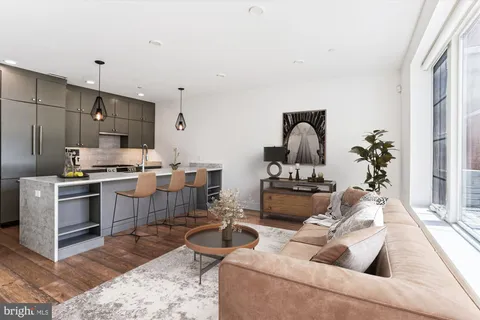 a living room with furniture and kitchen view
