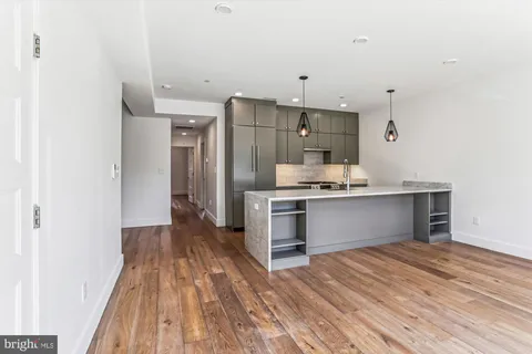 a view of kitchen with wooden floor and electronic appliances
