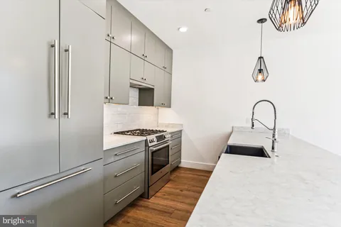a kitchen with a refrigerator and a sink