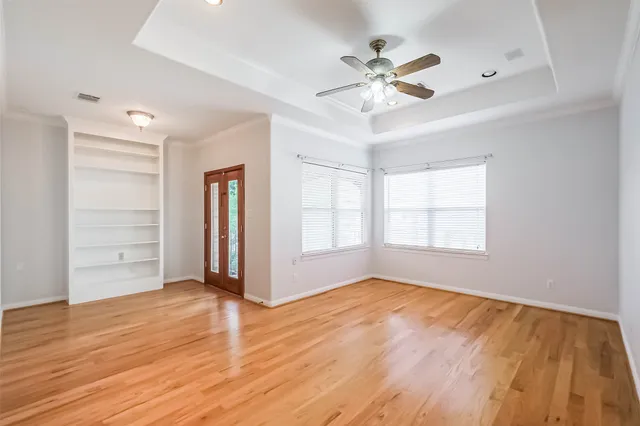 a view of empty room with wooden floor