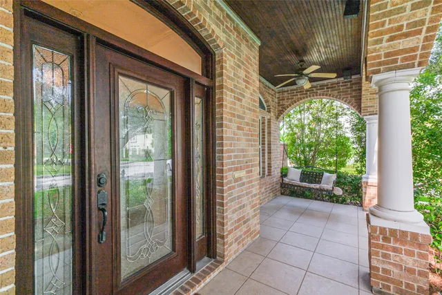 wooden floor fireplace and windows in an empty room