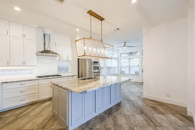 a kitchen with sink cabinets and wooden floor