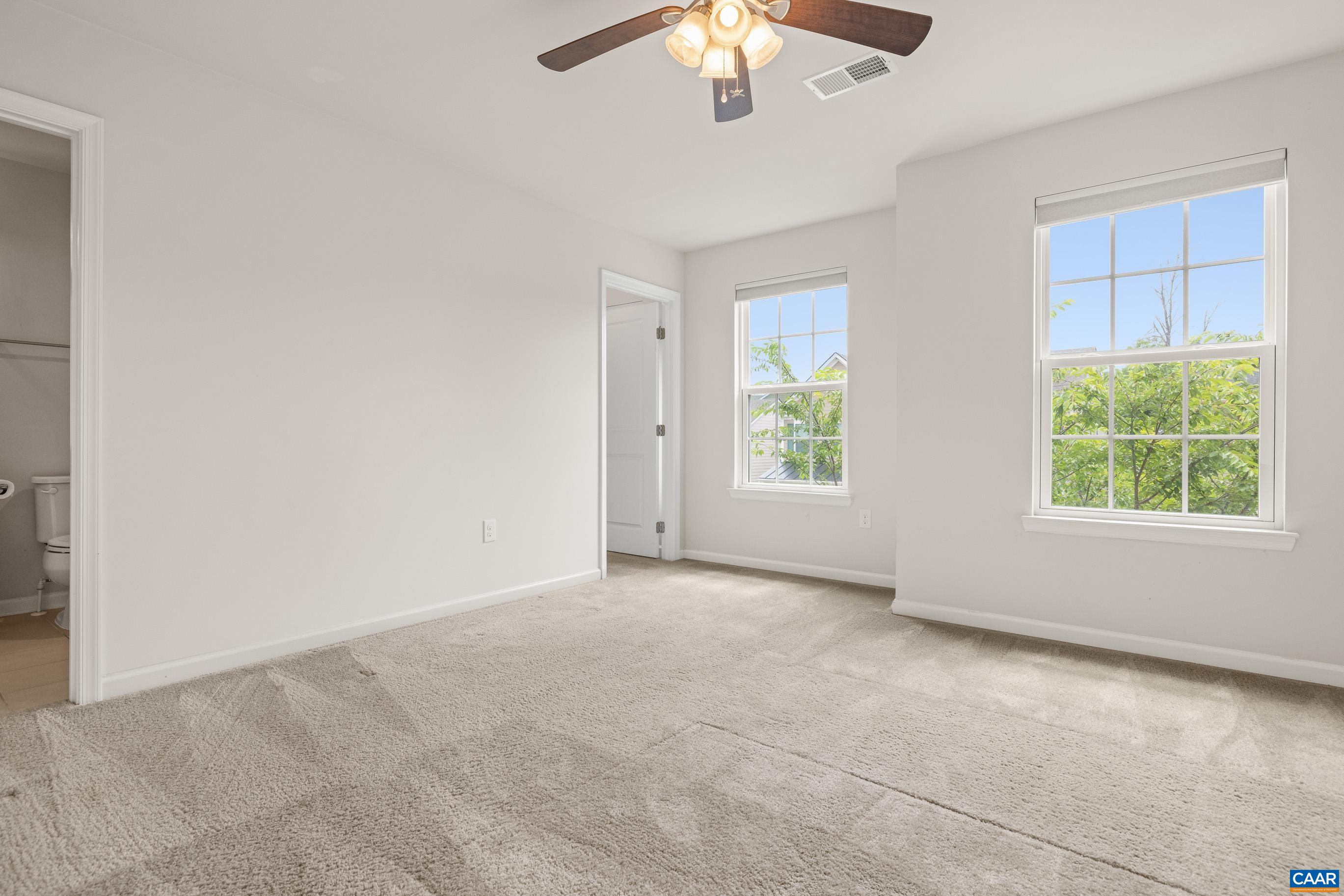 1622 Fowler Ridge Court Charlottesville, VA 22901 - Photo 57 of 75 an empty room with windows and chandelier fan