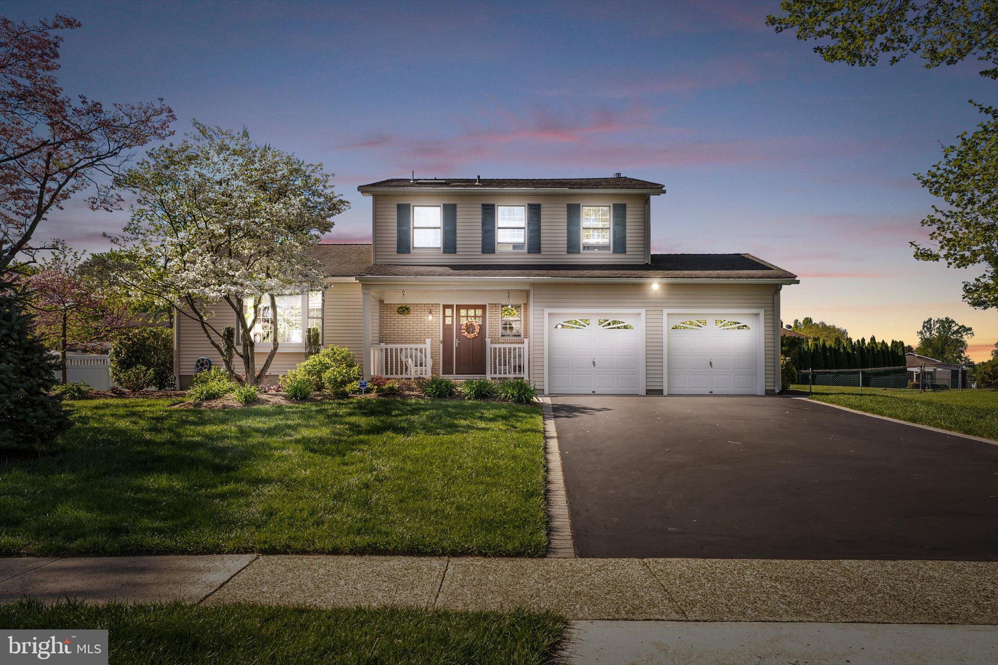 1111 Estates Boulevard Hamilton, NJ 08690 - Photo 2 of 47 a front view of a house with a yard and garage