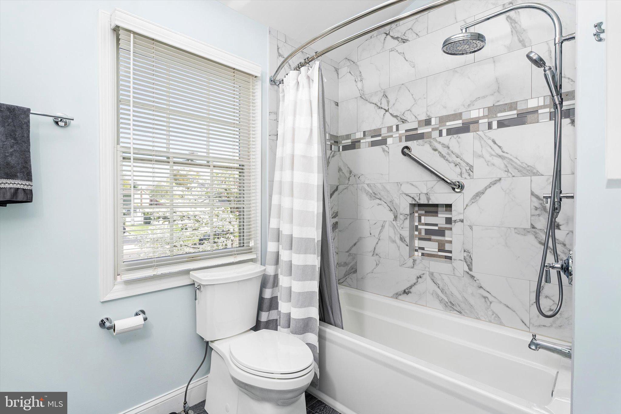 1111 Estates Boulevard Hamilton, NJ 08690 - Photo 28 of 47 a bathroom with a granite countertop toilet a sink and shower