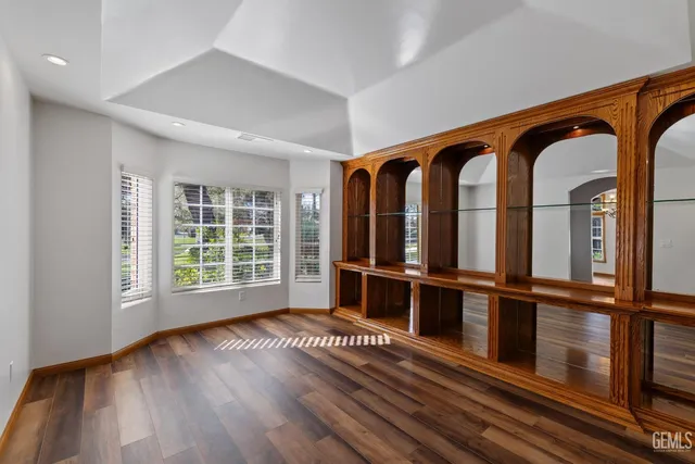 a kitchen with granite countertop a sink stove and cabinets