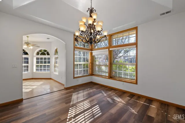 a kitchen with stainless steel appliances granite countertop wooden cabinets a sink and a refrigerator