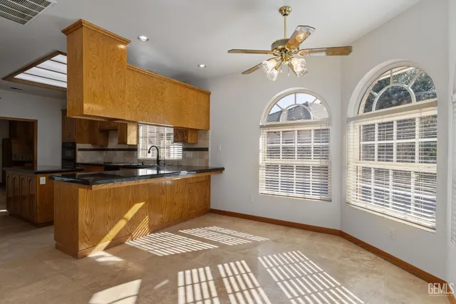 a kitchen with granite countertop a sink and a stove top oven