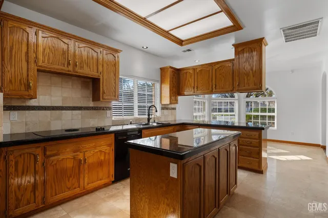 a kitchen with stainless steel appliances granite countertop a sink and cabinets