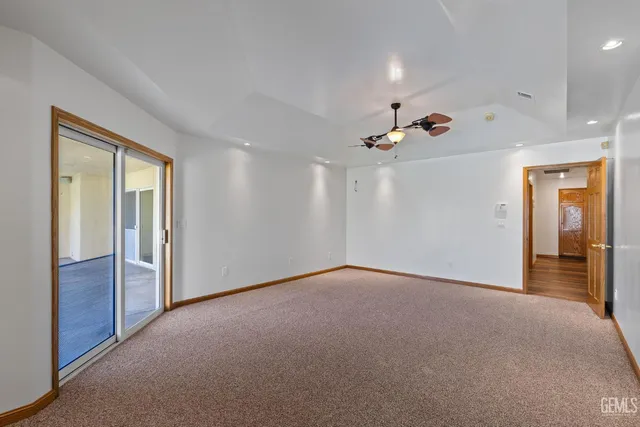 a en suite bathroom with a granite countertop sink and a mirror