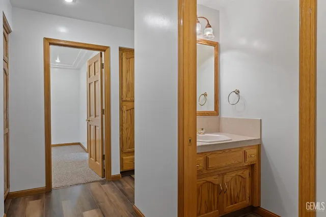 a view of a house with a floor to ceiling window and wooden fence