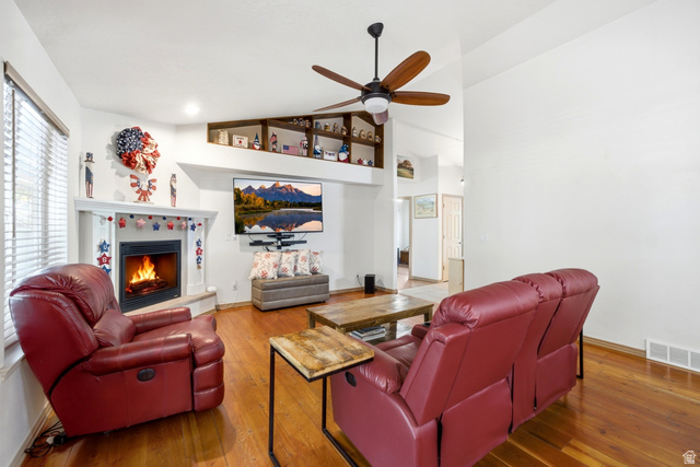 5196 Rodeo Circle Oakley, UT 84055 - Photo 11 of 57 Living area featuring wood-finish flooring, a white-mantled fireplace, and an integrated ceiling fan