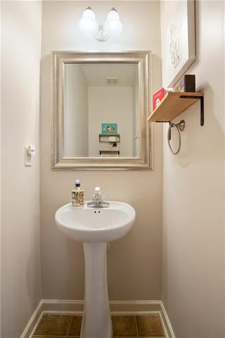 a bathroom with a sink mirror and vanity